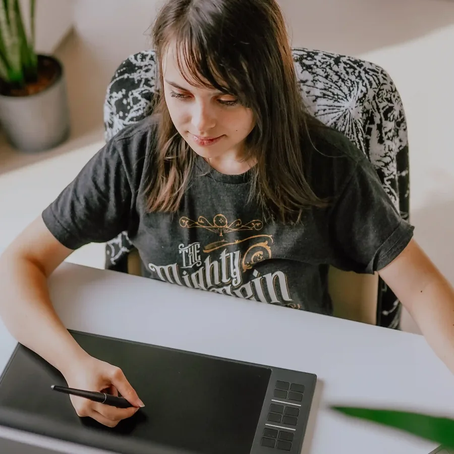 Lily drawing on a graphics tablet at her desk