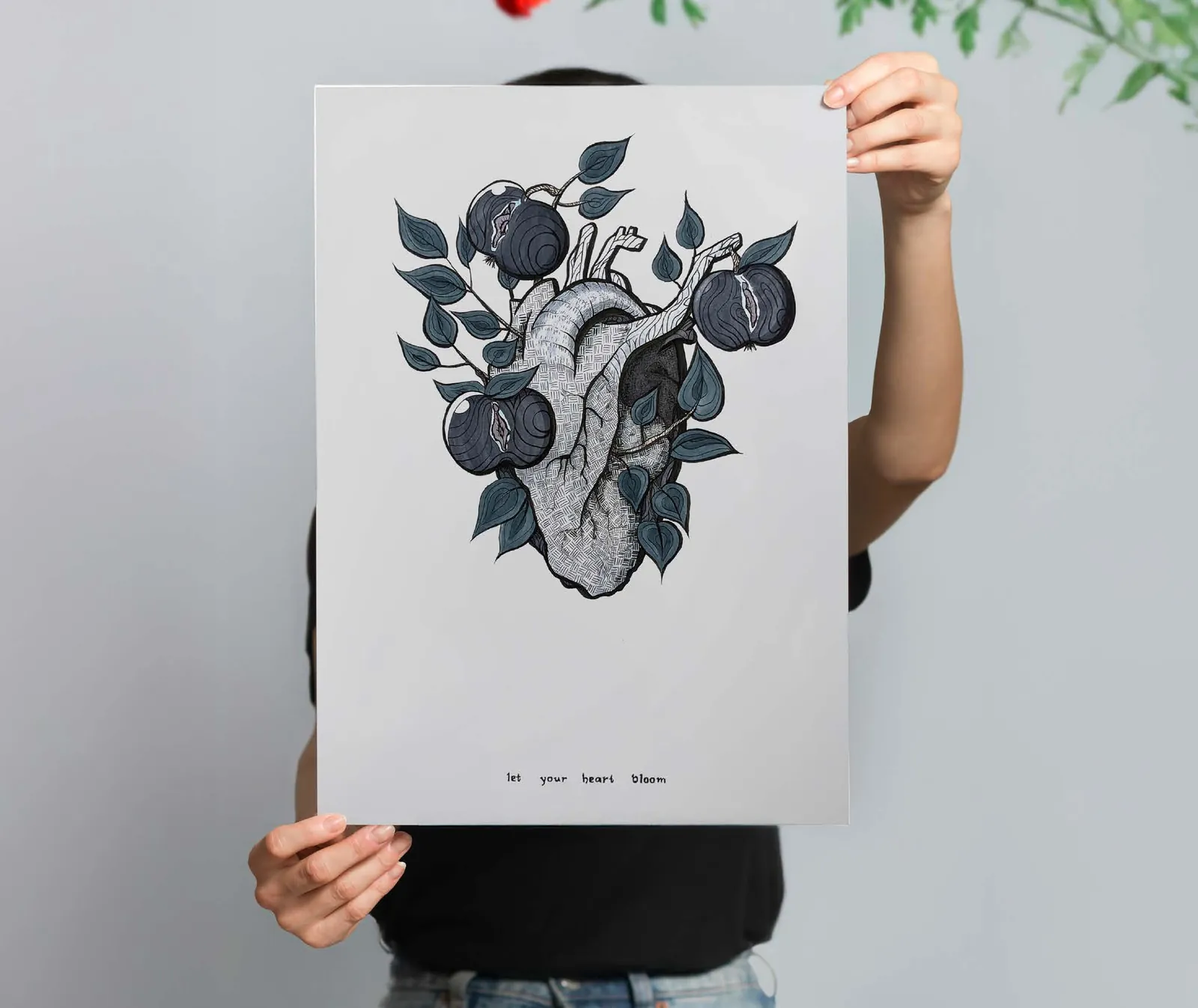 A person holding a poster with the Schweineheart heart illustration