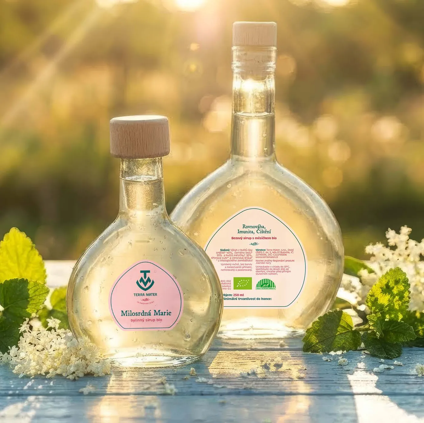 Terra Mater syrup bottle with a pastel label in a sunny meadow